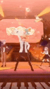 a group of people are standing on a stage in front of a large screen .