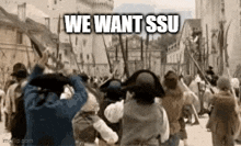 a group of people are standing in a crowd holding guns and a sign that says we want ssu .