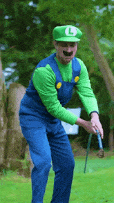 a man dressed in a luigi costume is holding a golf club