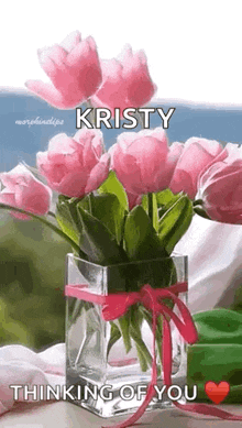 a vase filled with pink flowers with the name kristy on it .