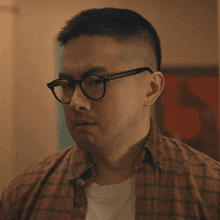 a man wearing glasses is asking what