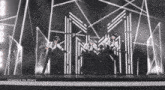 a group of men are dancing on a stage with the words " dragging me down " written on the bottom