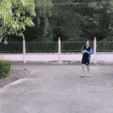 a man in a blue shirt and black shorts is running down the street