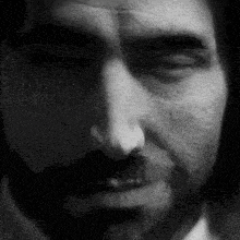 a close up of a man 's face with his eyes closed