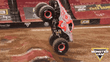 a monster jam advertisement shows a monster truck doing a handstand