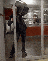 a man is carrying a briefcase through a doorway