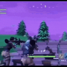 a group of people are playing a video game in a field with trees in the background .