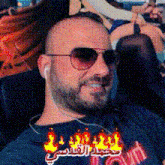 a man with a beard wearing sunglasses and a shirt that says town