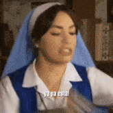 a woman in a nun costume is making a funny face .