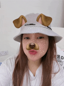 a girl wearing a bucket hat with a dog face on her face