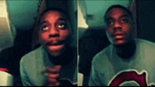 a man is making a funny face while wearing a green shirt with a red g on it .