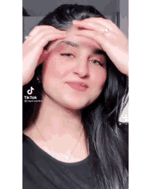 a woman 's face is shown in a tiktok video with a ring on her finger