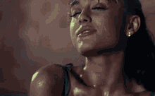 a close up of a woman 's face with sweat coming out of it .