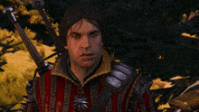 a man with a bloody face is holding a sword in his hand