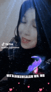 a tiktok video of a girl with blue hair and the words wa ' alaikumsalam wr.wb