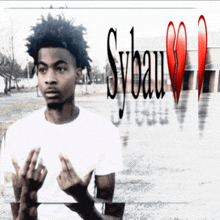 a young man stands in front of a broken heart and the word sybau