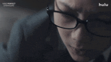 a close up of a woman wearing glasses with the words what happened below her