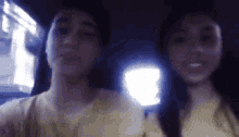 a man and a woman are sitting in a car and smiling .