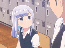 a girl with purple hair is sitting in a chair next to a man