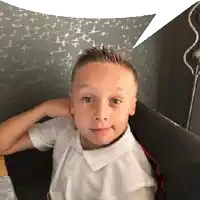 a young boy in a white shirt with a speech bubble behind him