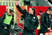 a woman wearing a jacket that says orlen on the front