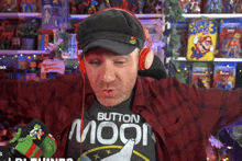 a man wearing headphones and a black shirt that says button moon