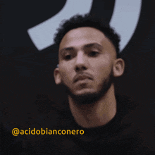 a close up of a man 's face with the name acidobianconero written in yellow