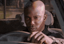 a man is driving a car with the watermark inshot on the bottom right