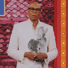a man in a white suit with a picture of a rabbit on his jacket