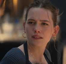 a close up of a woman 's face with a serious look on her face