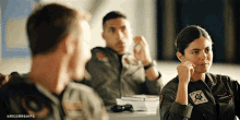 a woman in a military uniform has a patch on her chest that says army
