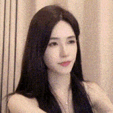 a close up of a woman 's face with long black hair .
