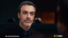 a man in a suit and tie is featured on a nbc ad
