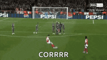a soccer player kicking a ball with the word corrr written below him