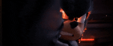 a close up of a cartoon character 's face with fire coming out of it 's eyes .