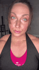 a woman wearing a pink top that says belever