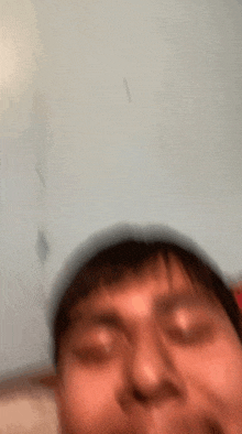a blurry picture of a man making a funny face .