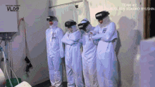 a group of people in white jumpsuits are standing next to each other and the words team # 2 are on the bottom
