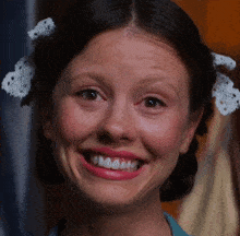a close up of a woman 's face with a smile on her face