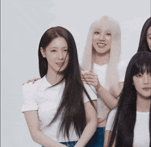 a group of young women with long hair are posing for a photo