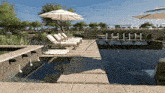 a large swimming pool with umbrellas and chairs around it