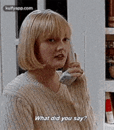 a woman is talking on a cell phone and saying what did you say .