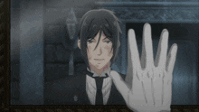 a man in a tuxedo and white gloves holds his hand up