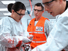 a man wearing an orange vest that says emergency md on it