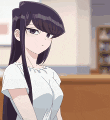 a girl with long black hair and a white shirt is standing in front of a counter .