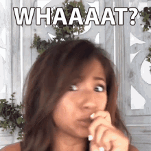 a woman is making a funny face and the words whaaaat are above her