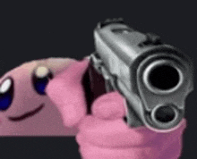 a pink worm is holding a gun and pointing it at the camera .
