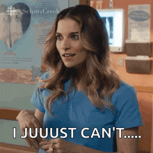 a woman in a blue scrub top is saying i jujust can 't