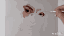 a person is painting a woman 's face with a brush and made in animatica