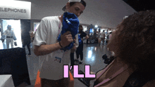 a man holds a blue balloon in front of a sign that says telephones